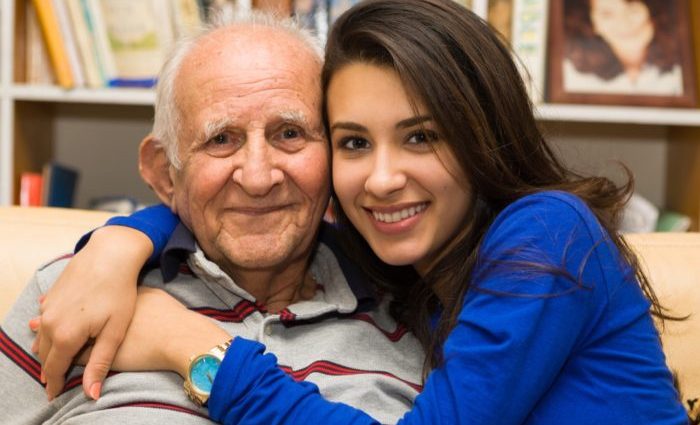 Grandfather and Granddaughter Elderly eighty plus year old man with granddaughter in a home setting.